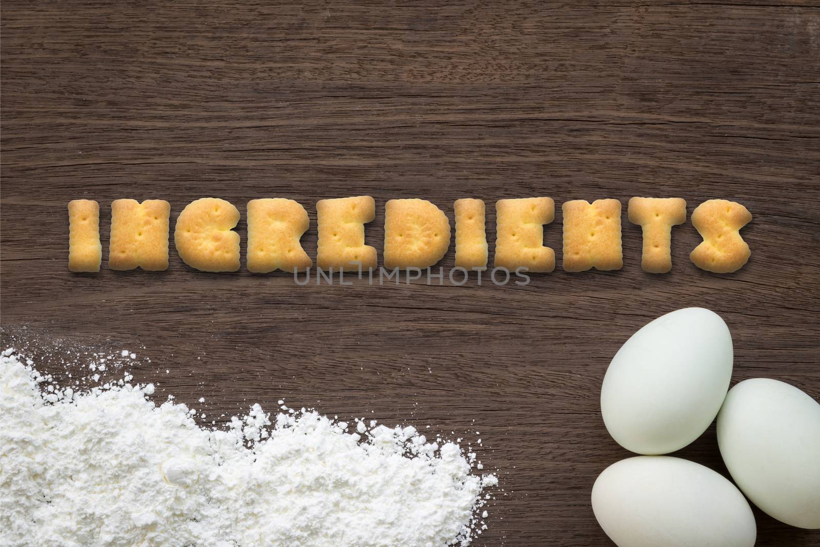 Alphabet cookies word INGREDIENTS on cooking table background by vinnstock