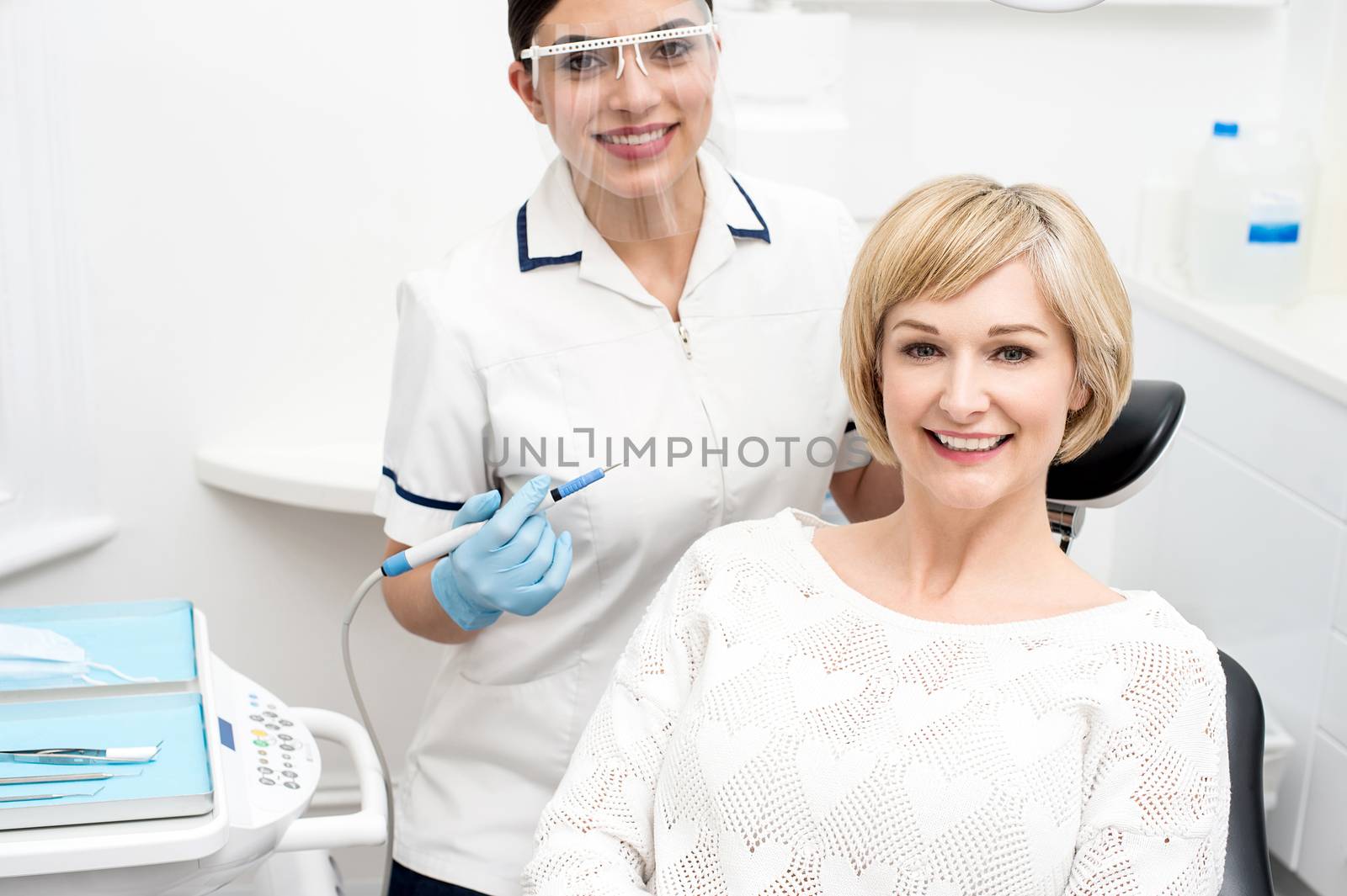 Happy woman patient sitting at stomatology clinic