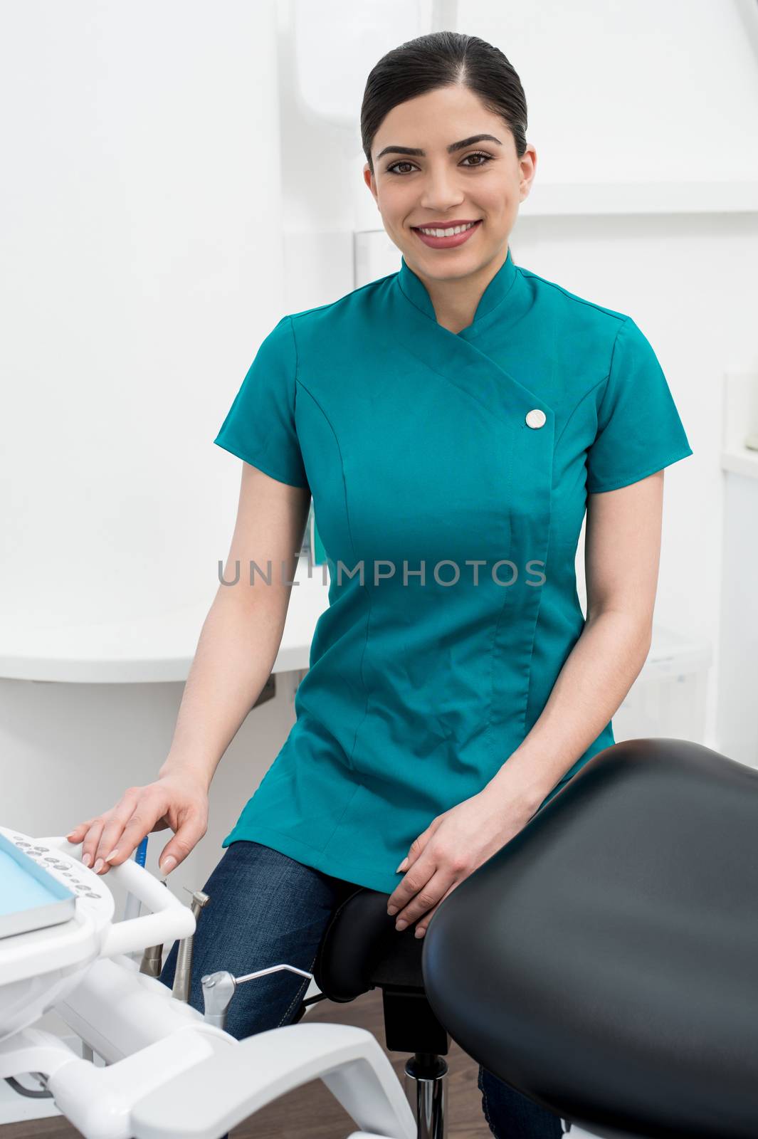 Female assistant seated in dental office