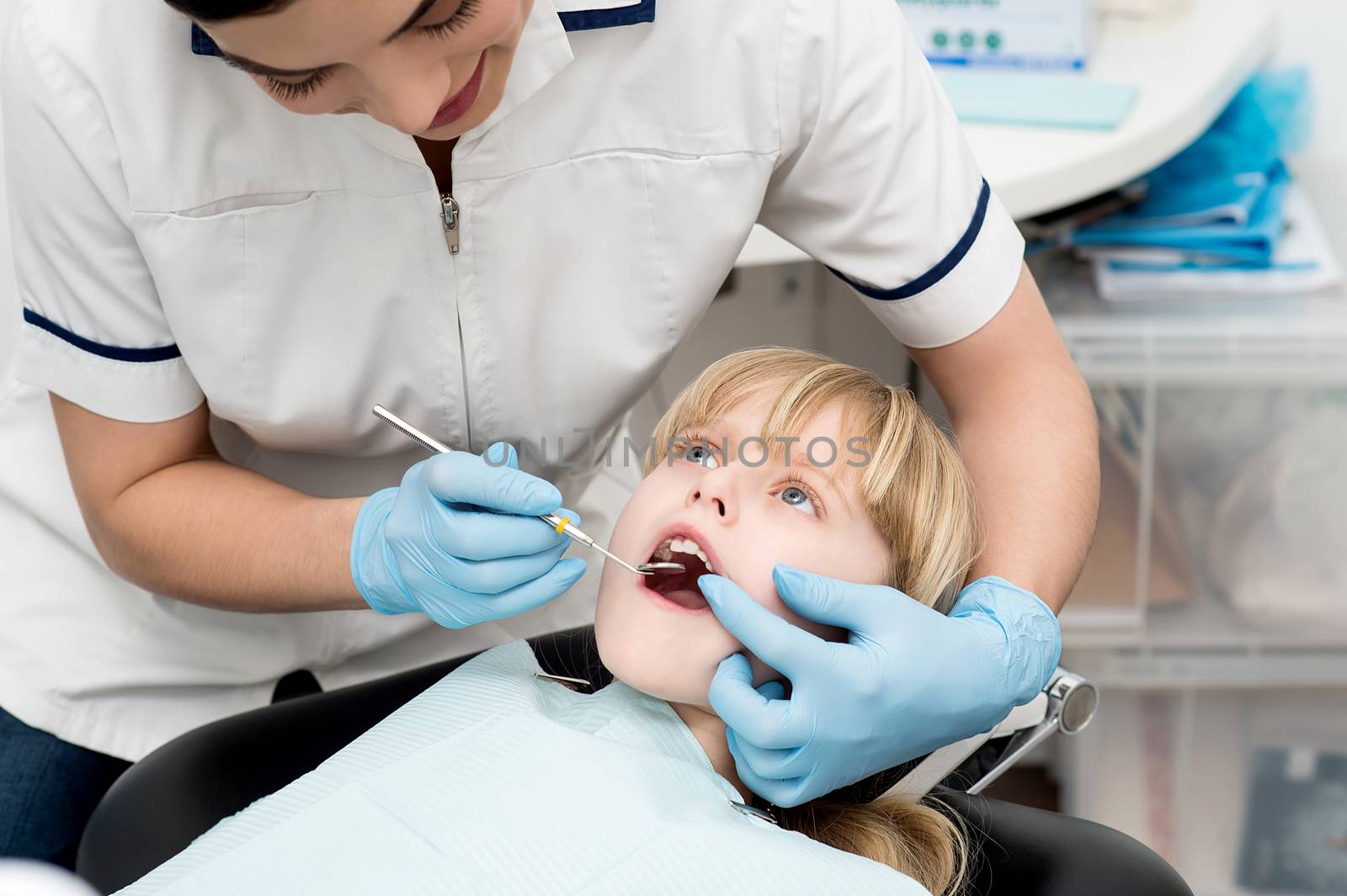 Little girl on dental check up. by stockyimages