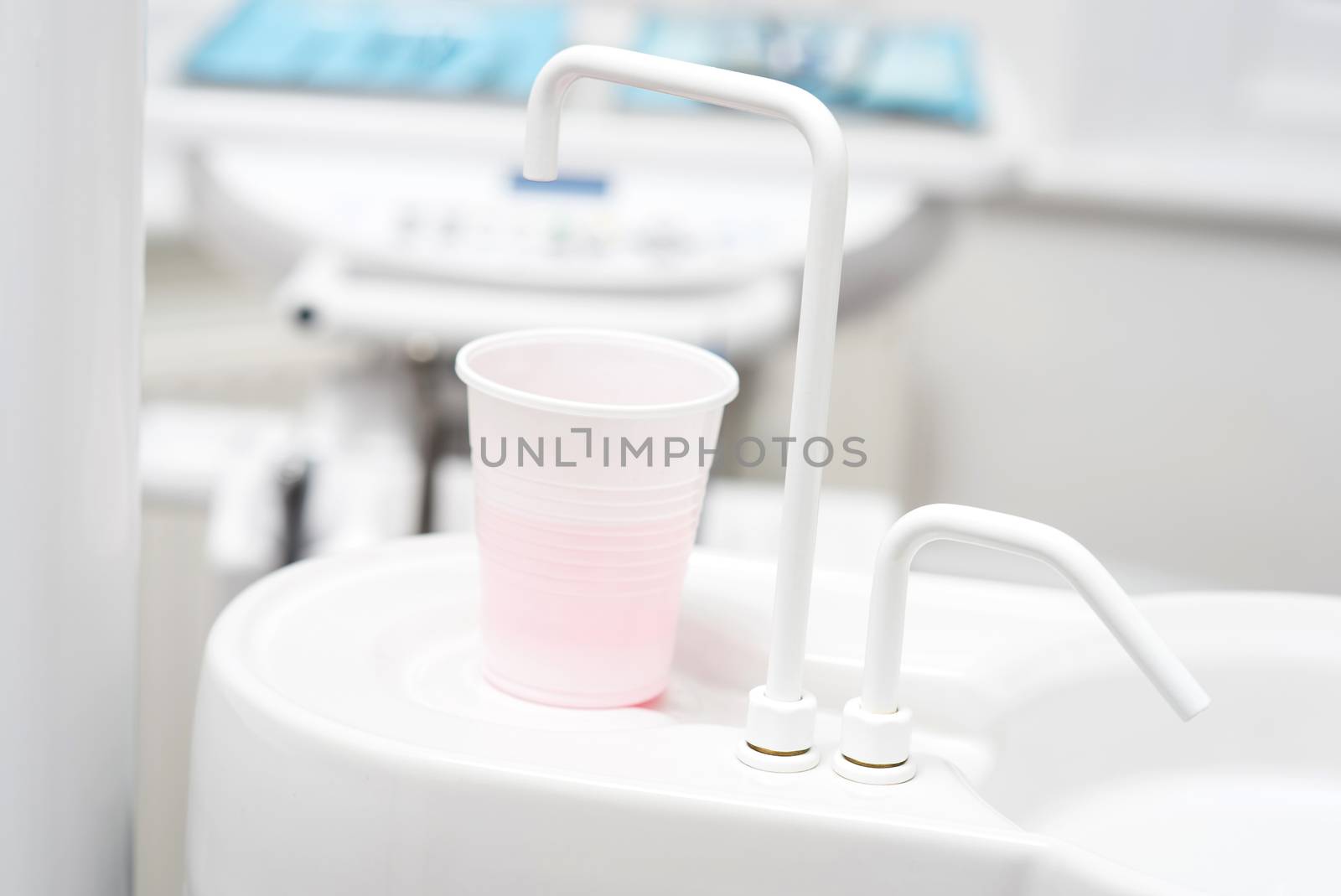 Cup of water in dental clinic by stockyimages