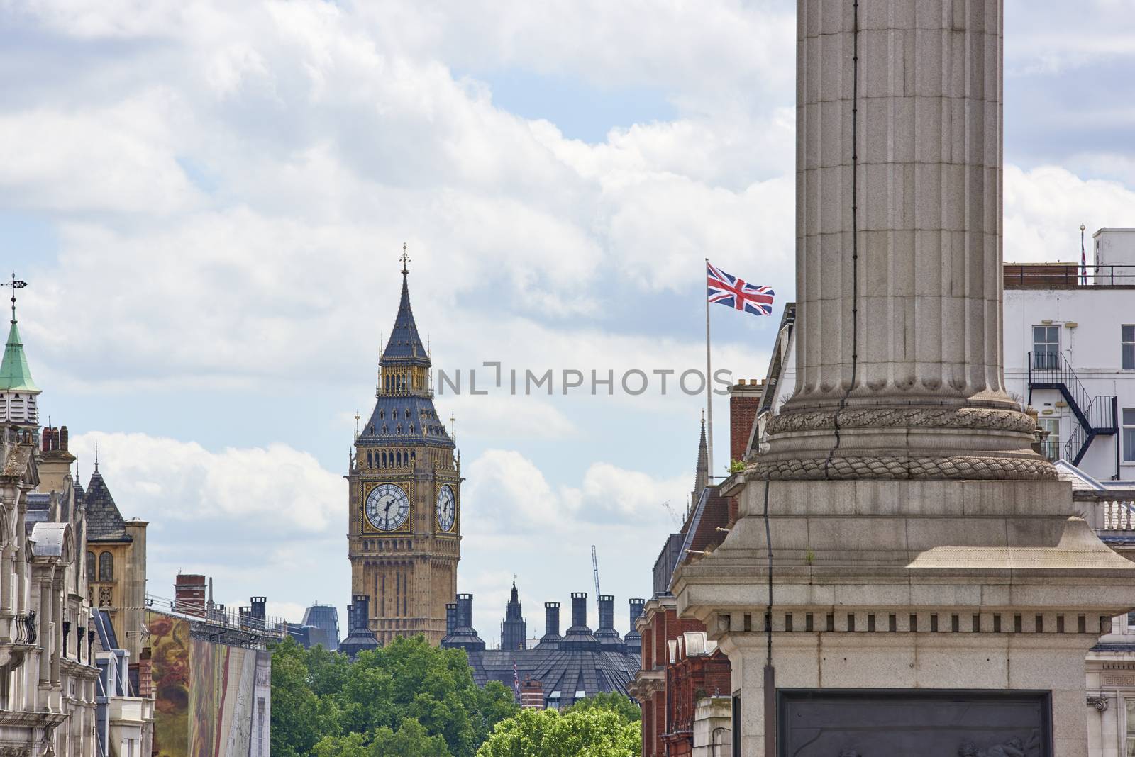 Cropped cityscape with Big Ben prominent in the background on a cloudy summer day in London, UK.