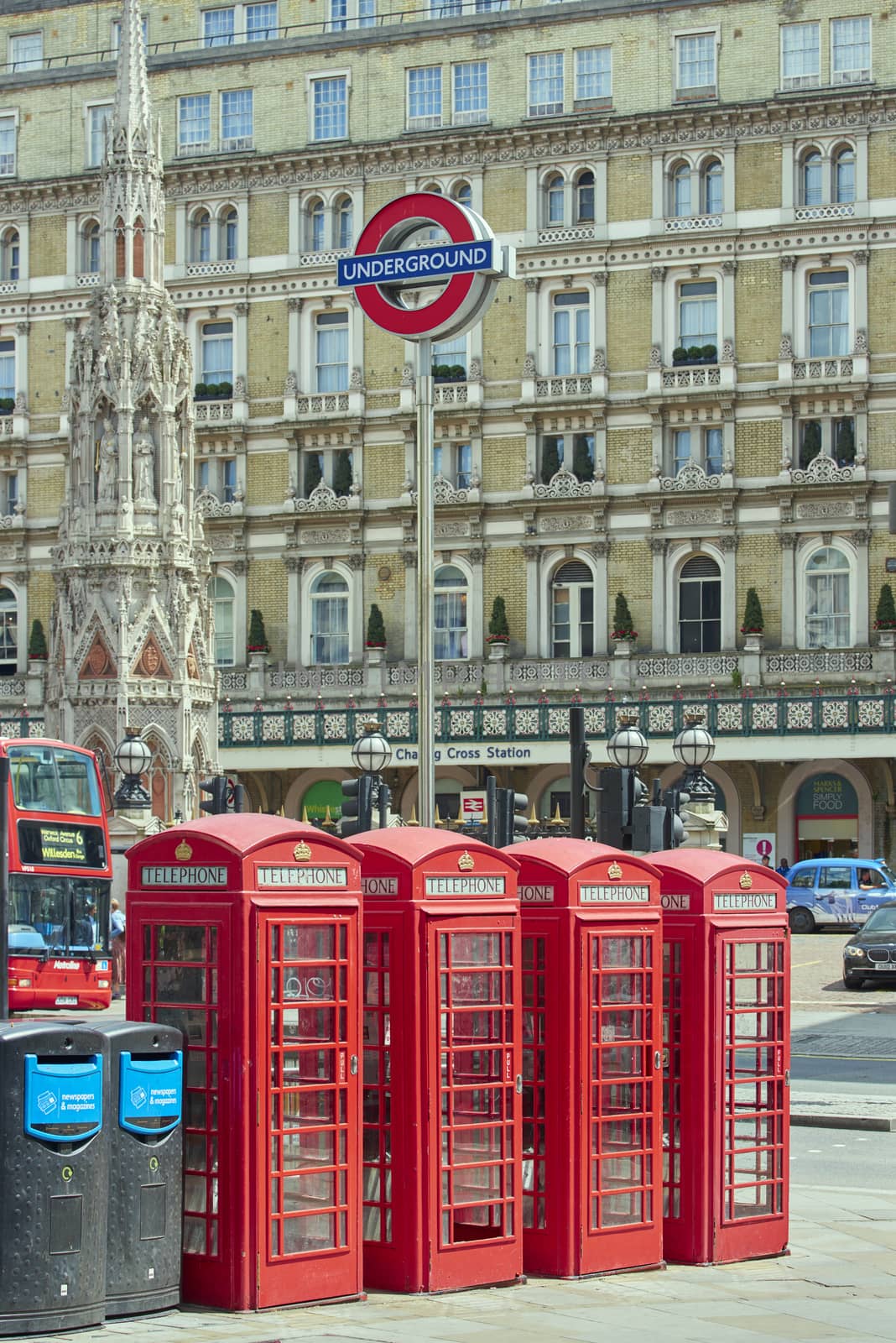 LONDON, UK - JUNE 15: Four traditional red phone booth with underground sign in front of Charing Cross station. June 15, 2015 in London.
