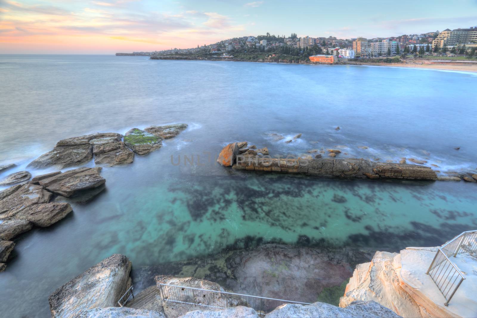 High views from the cliff top overlooking the northern rockpool at Coogee in Sydney's eastern suburbs.  Giles Baths is a natural rock pool, known as the Bogey hole  and beyond are its three southern rock pools