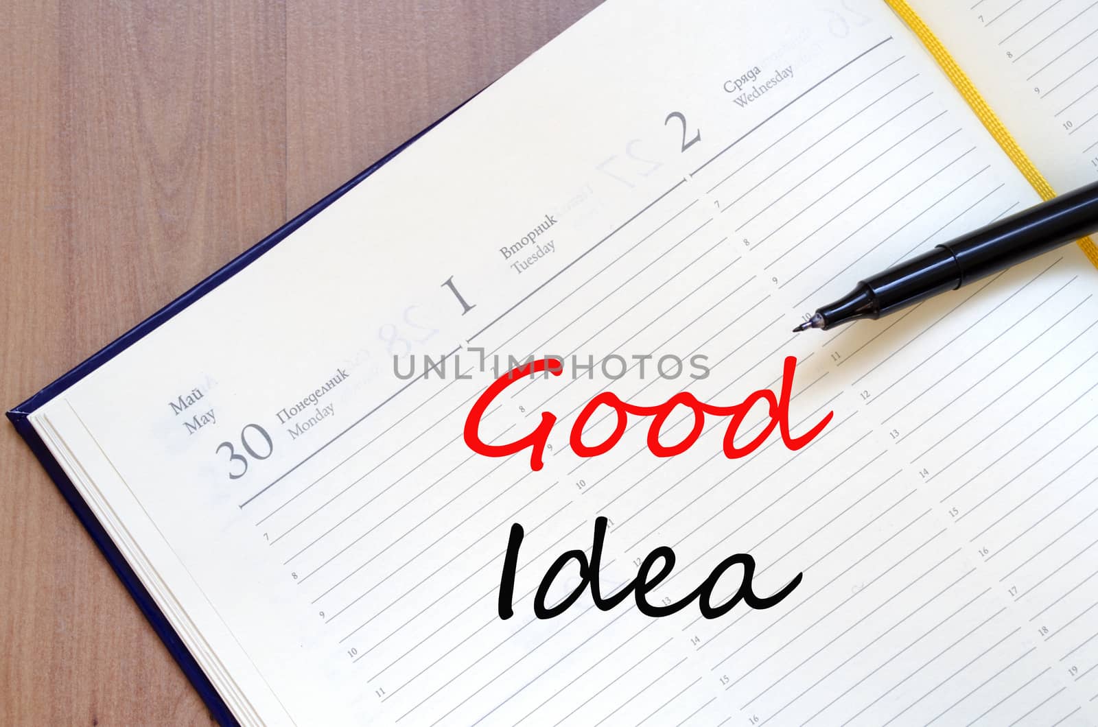 Yellow blank notepad on office wooden table and text concept