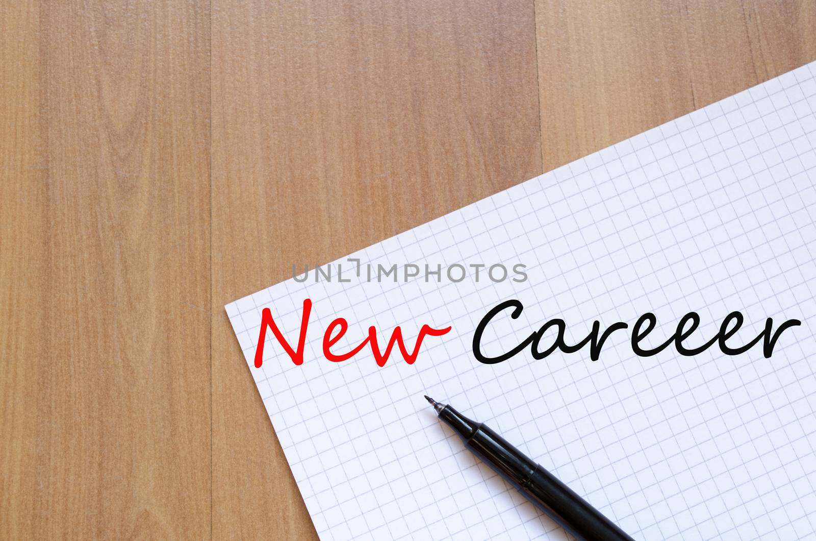 White blank notepad on office wooden table and text concept