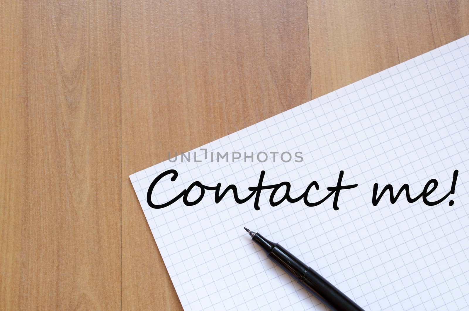White blank notepad on office wooden table and text concept