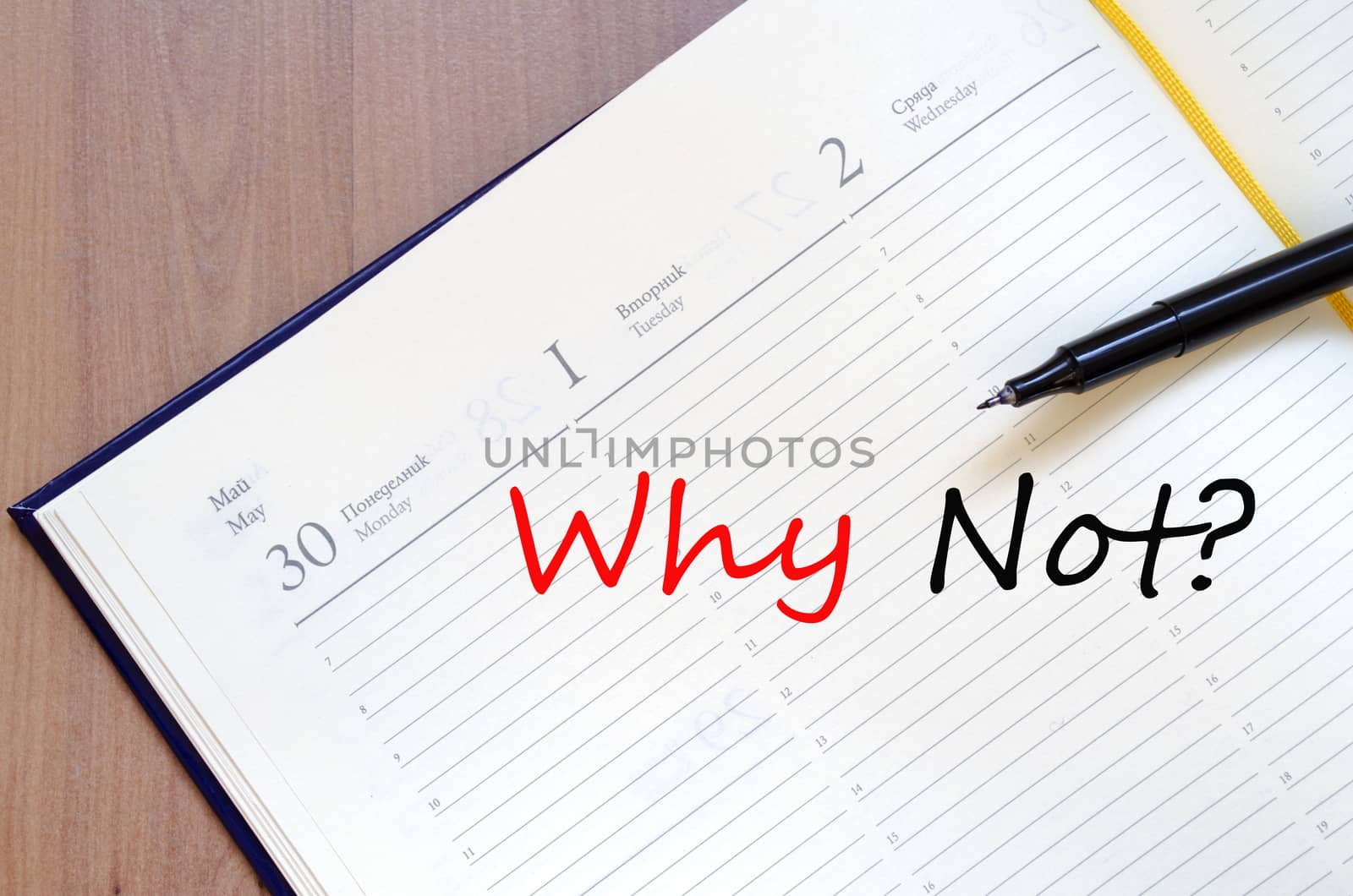 Yellow blank notepad on office wooden table and text concept
