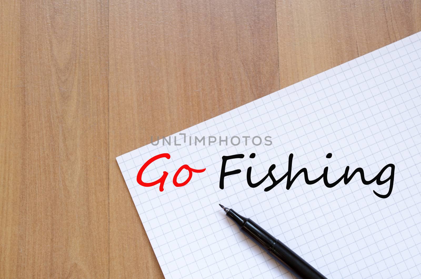 White blank notepad on office wooden table and text concept