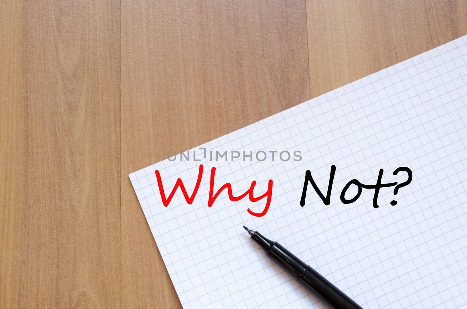 White blank notepad on office wooden table and text concept