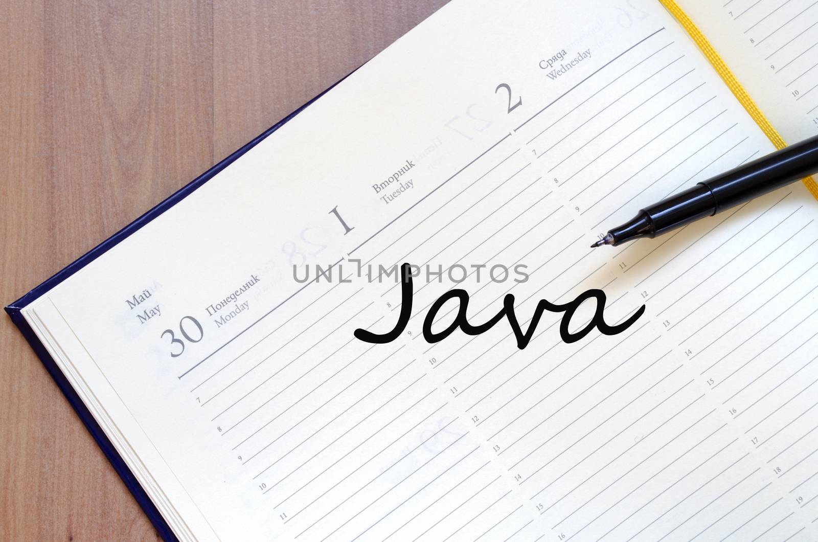 Yellow blank notepad on office wooden table and text concept