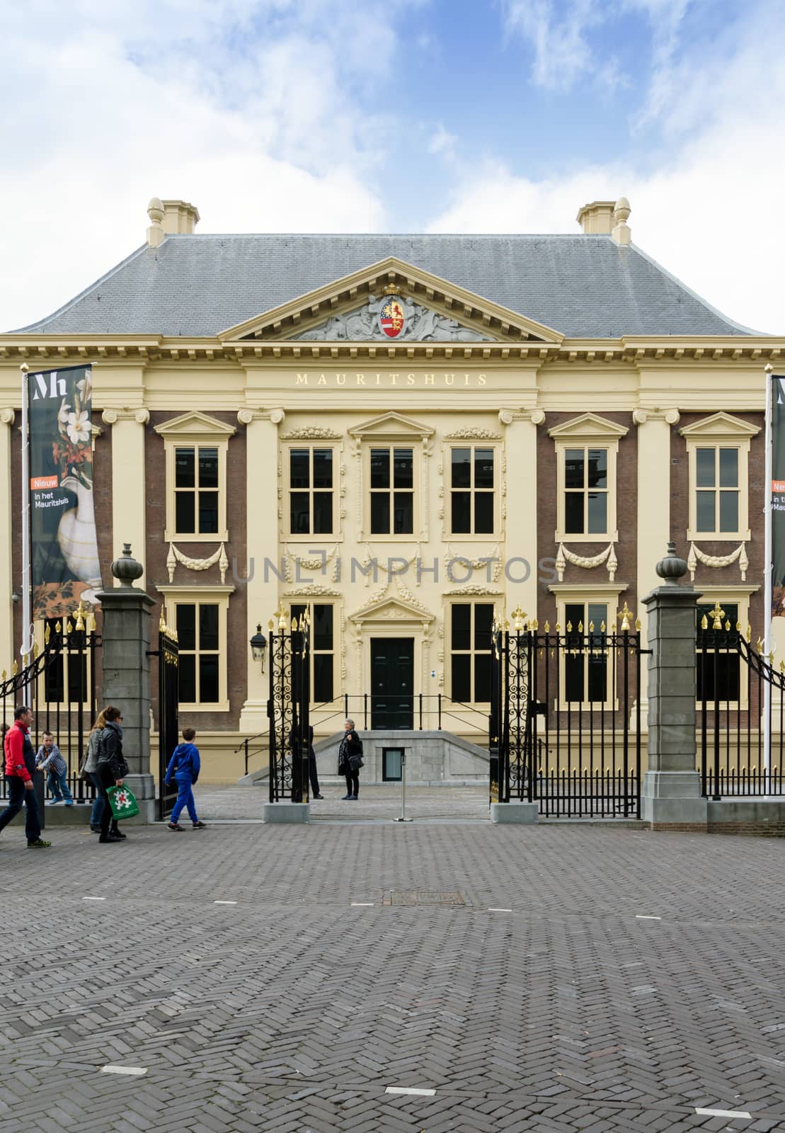 The Hague, Netherlands - May 8, 2015: Tourists visit Mauritshuis Museum in The Hague, Netherlands.The museum houses the Royal Cabinet of Paintings which consists of 841 objects, mostly Dutch Golden Age paintings.