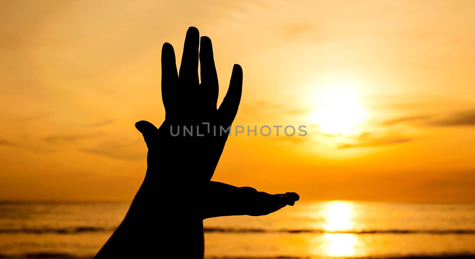 Hand with color of the sunset, Beautiful nature, Pathong beach Thailand