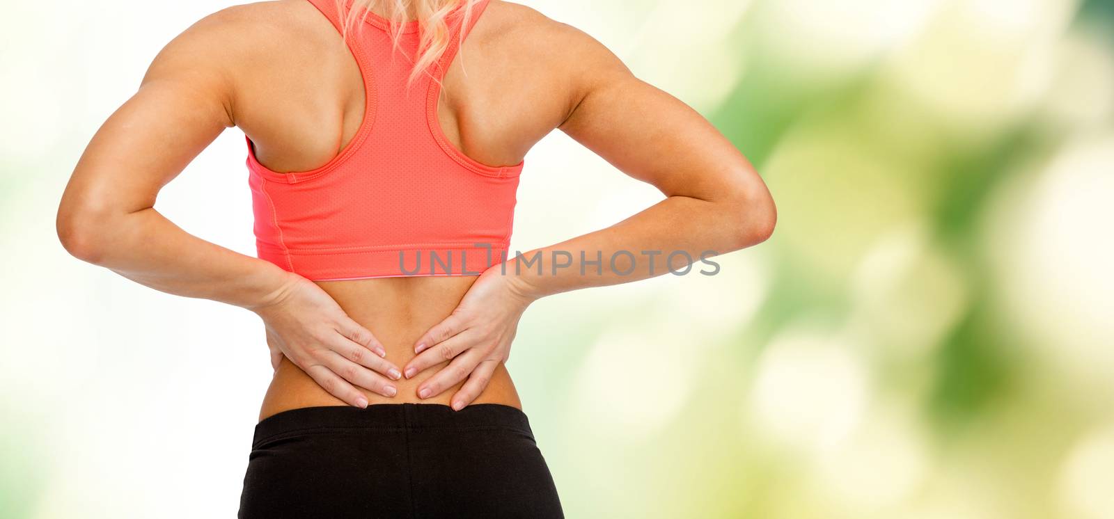 fitness, healthcare and medicine concept - close up of sporty woman touching her back