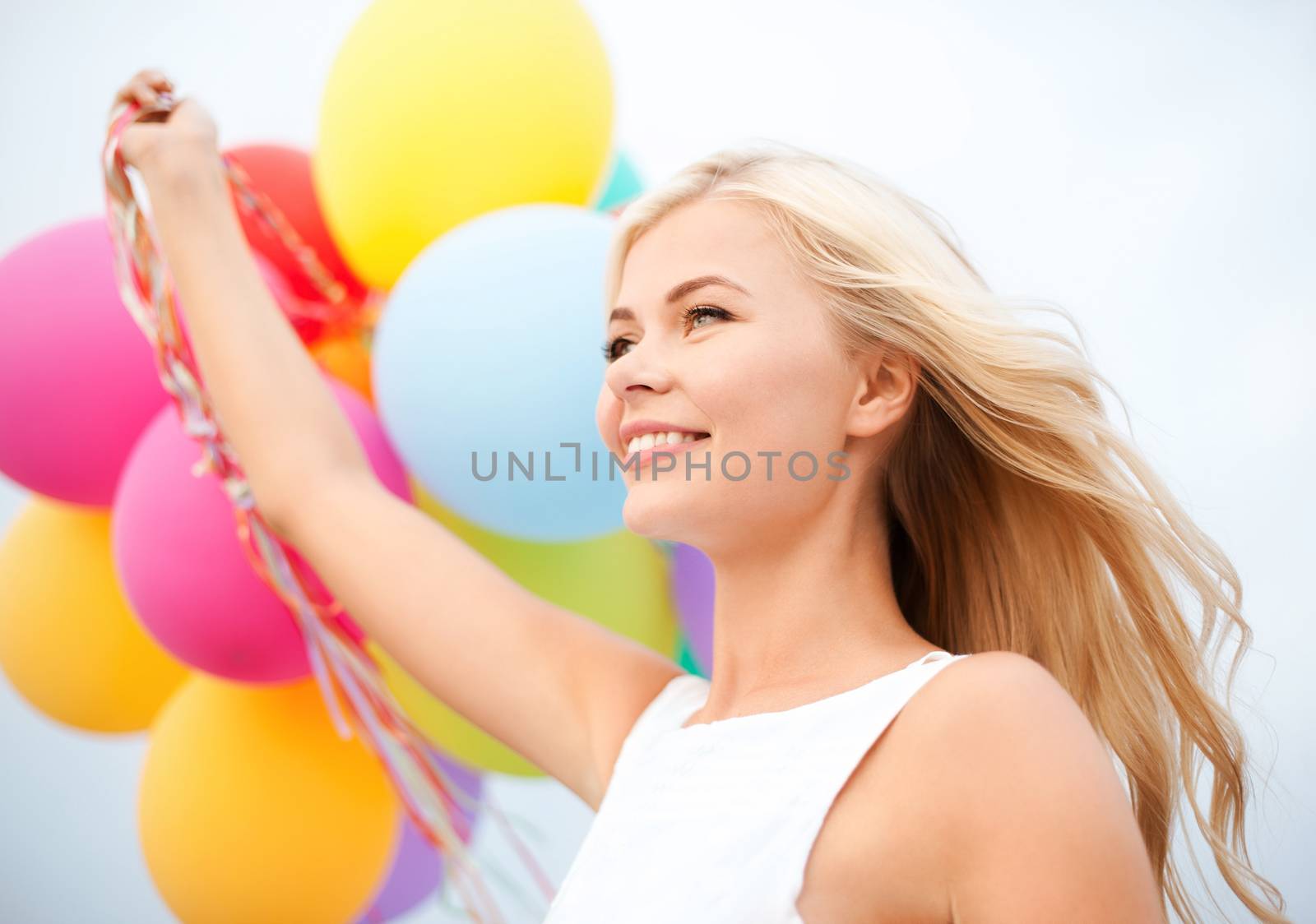 woman with colorful balloons outside by dolgachov