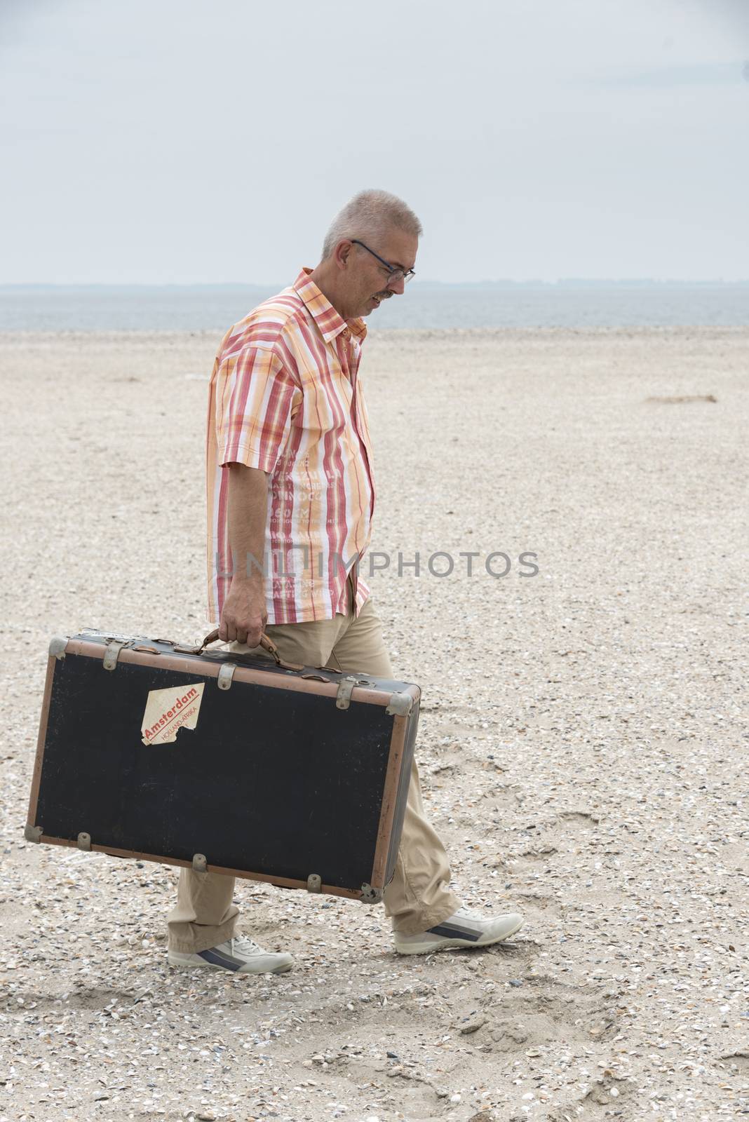  man with old suitcase   by compuinfoto
