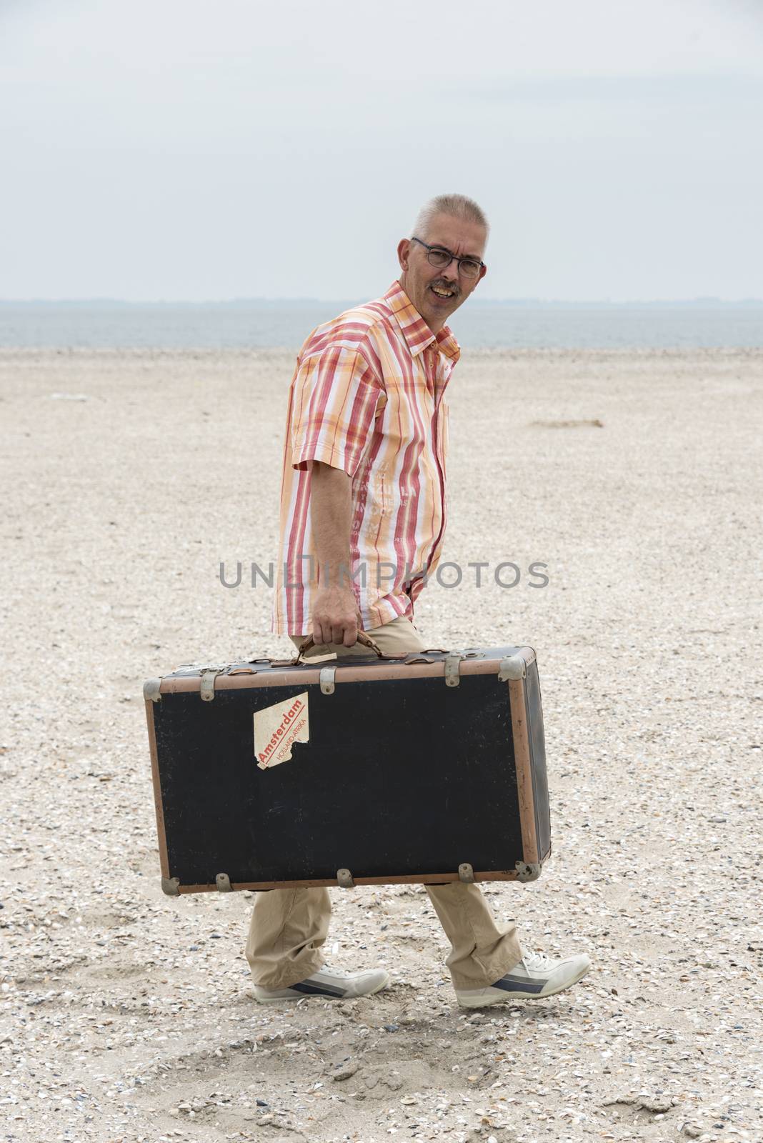  man with old suitcase   by compuinfoto