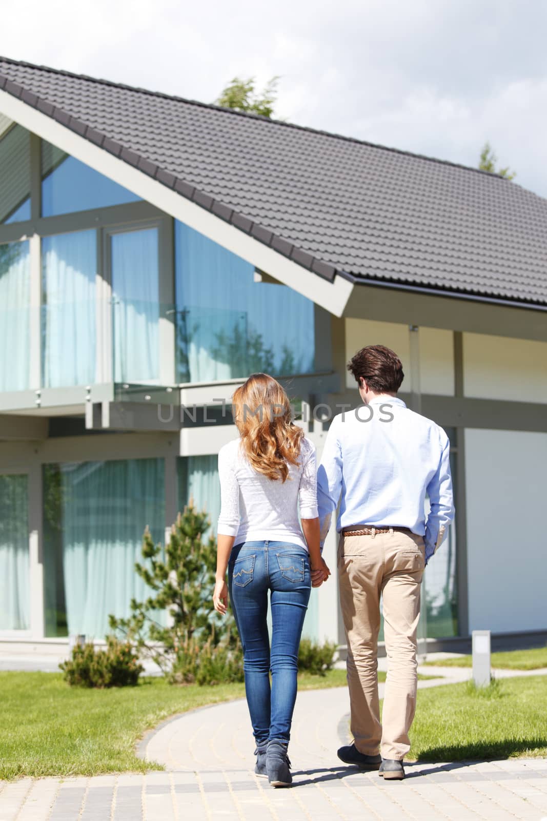 couple walking towards house by ALotOfPeople