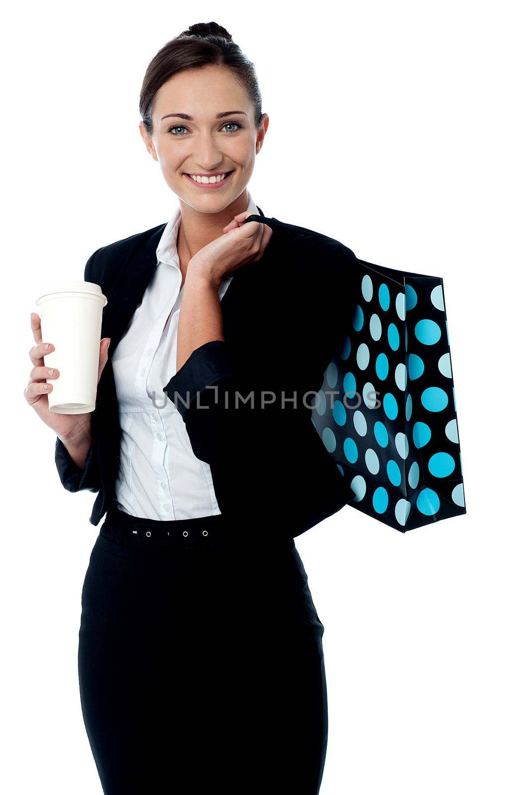 Woman holding coffee cup and shopping bag by stockyimages