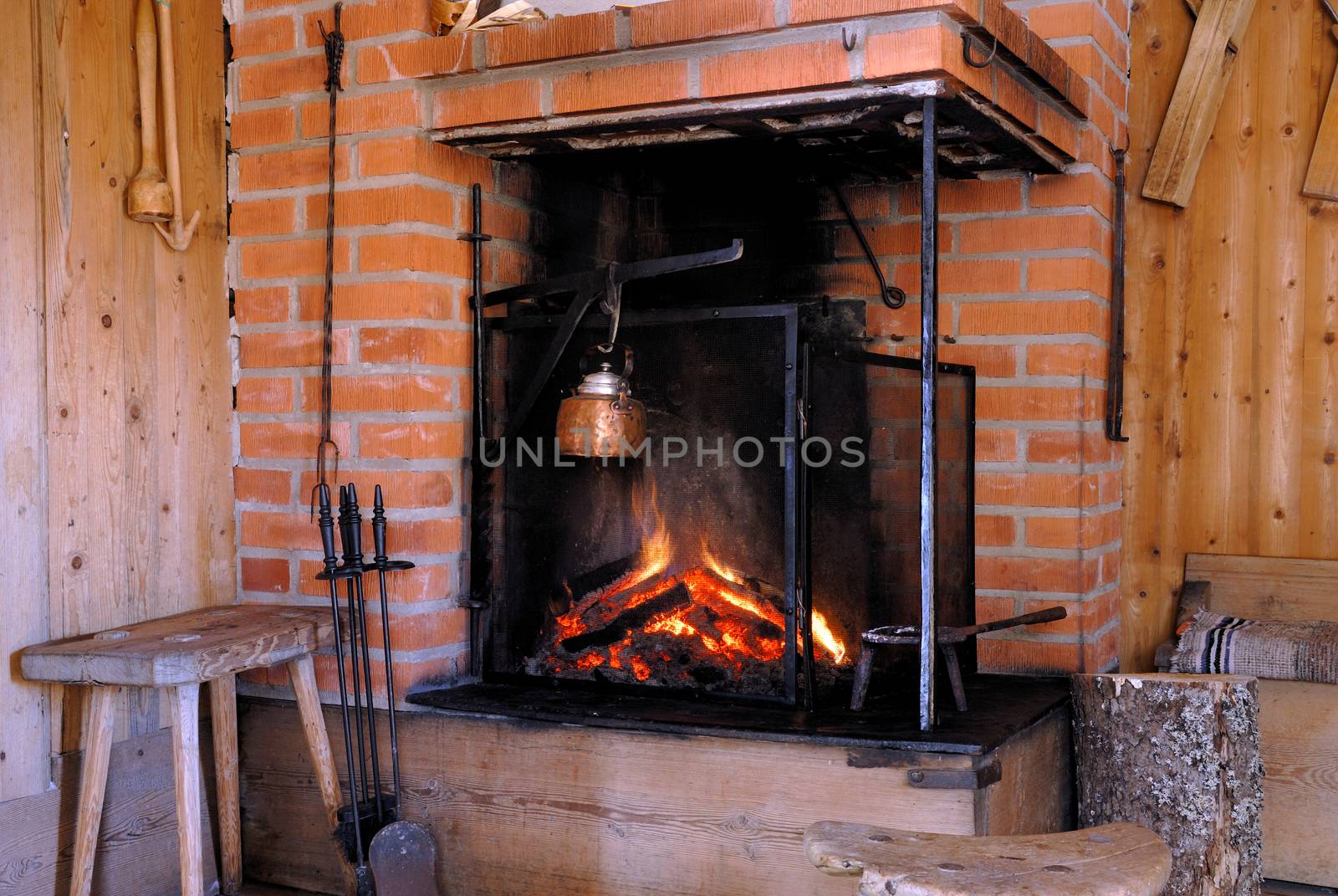 Wood fire in an old style wooden log cabin. A small house in Dalarna, Sweden.