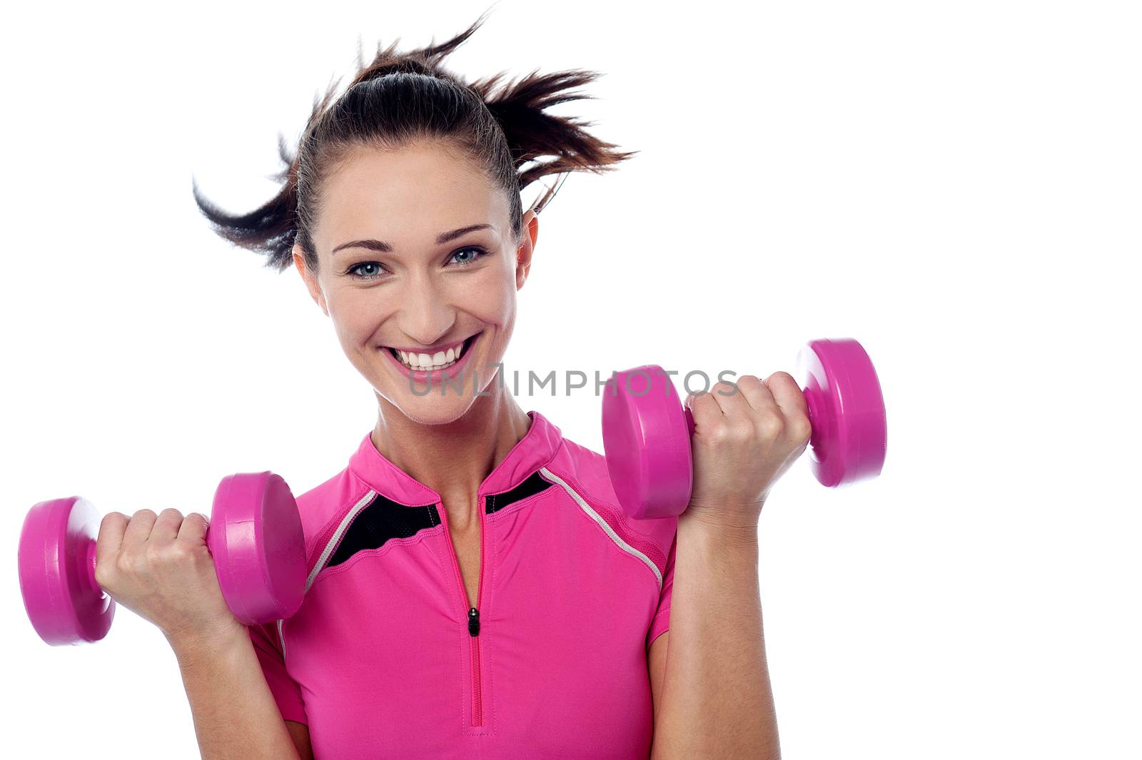 Young woman working out with pink dumbbells