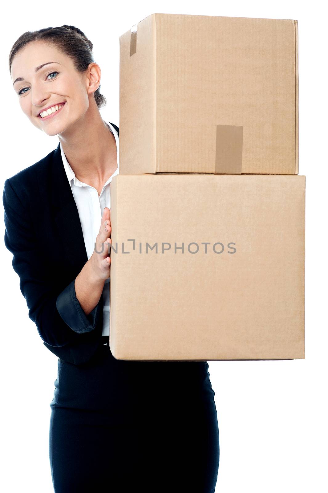 Happy woman posing behind the stack of boxes