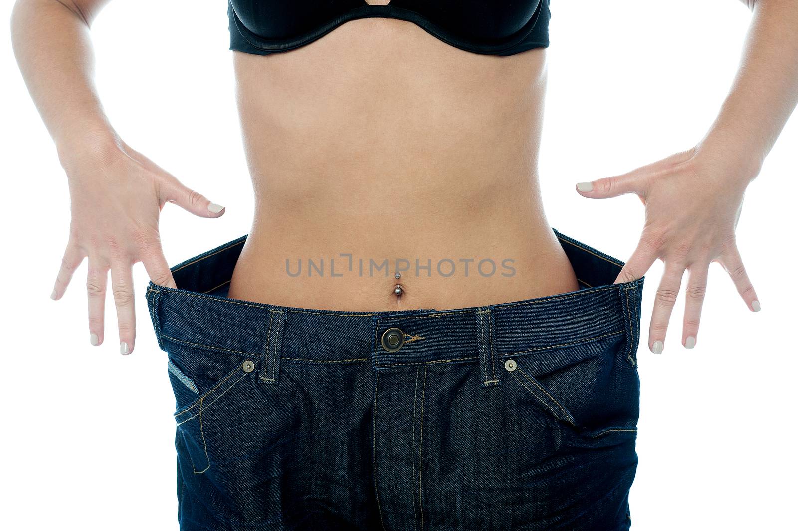 Woman shows her weight loss. by stockyimages