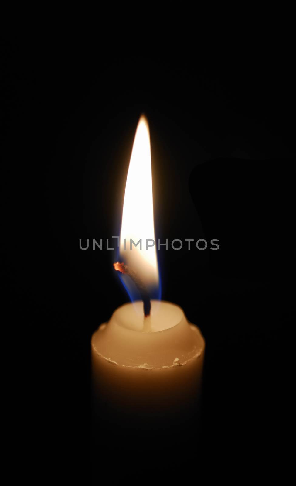 Single lit candle with quite flame by a40757