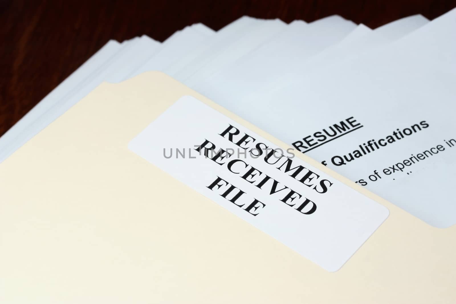 File with stack of resumes received