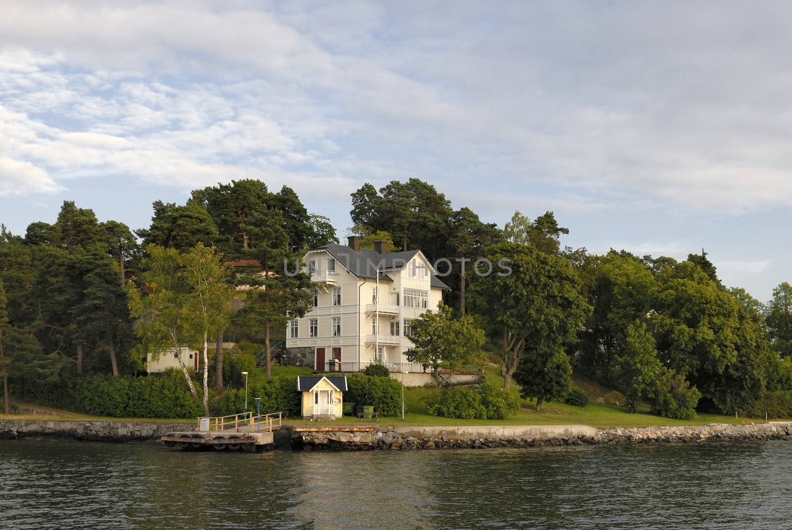 Idyllic houses by the baltic sea with jetties in a spring setting