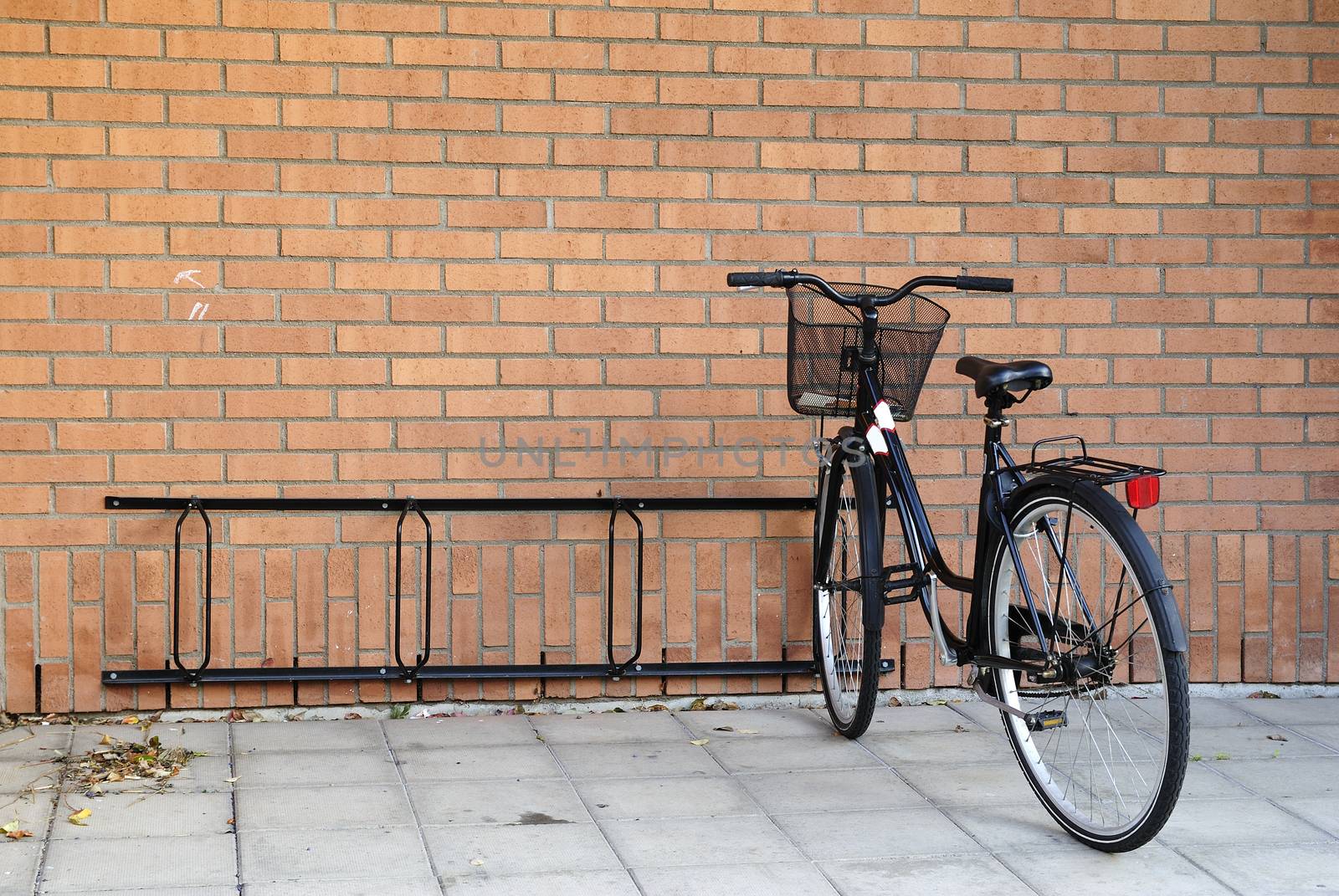 Generic Swedish bicycle parked in front of a typical brick wall.
