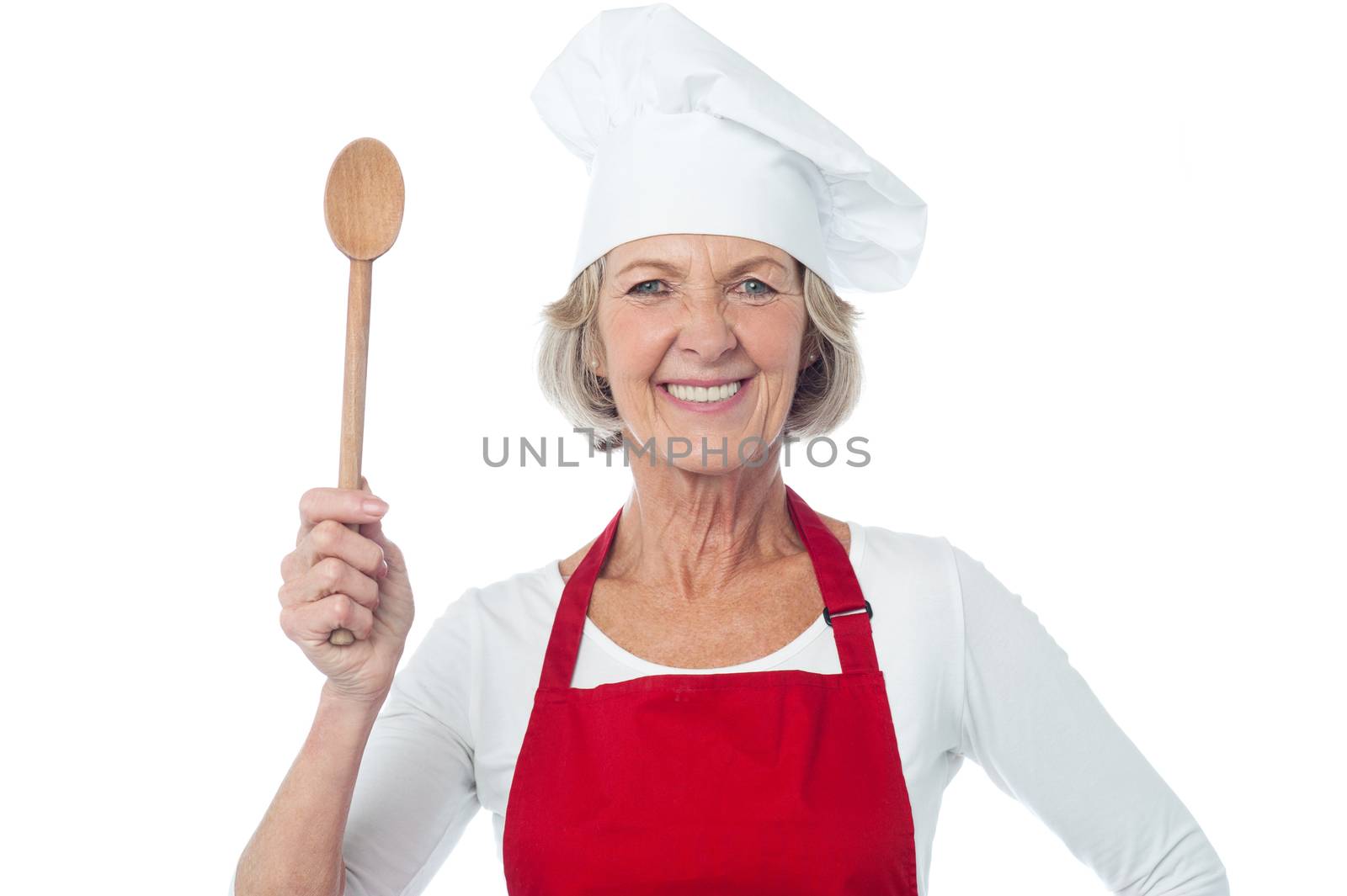 Aged female chef holding wooden spoon
