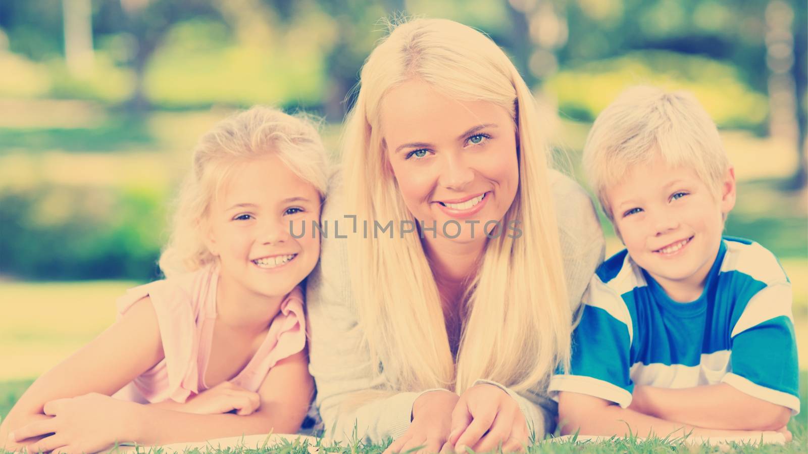 Mother with her children lying down during the summer by Wavebreakmedia