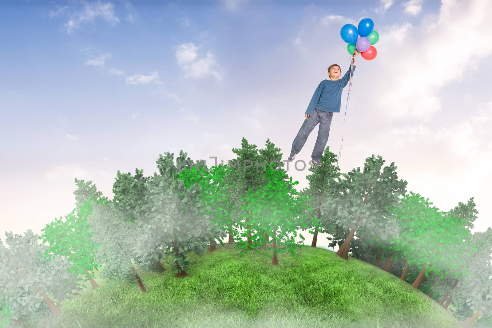 Cute boy holding balloons against beautiful orange and blue sky