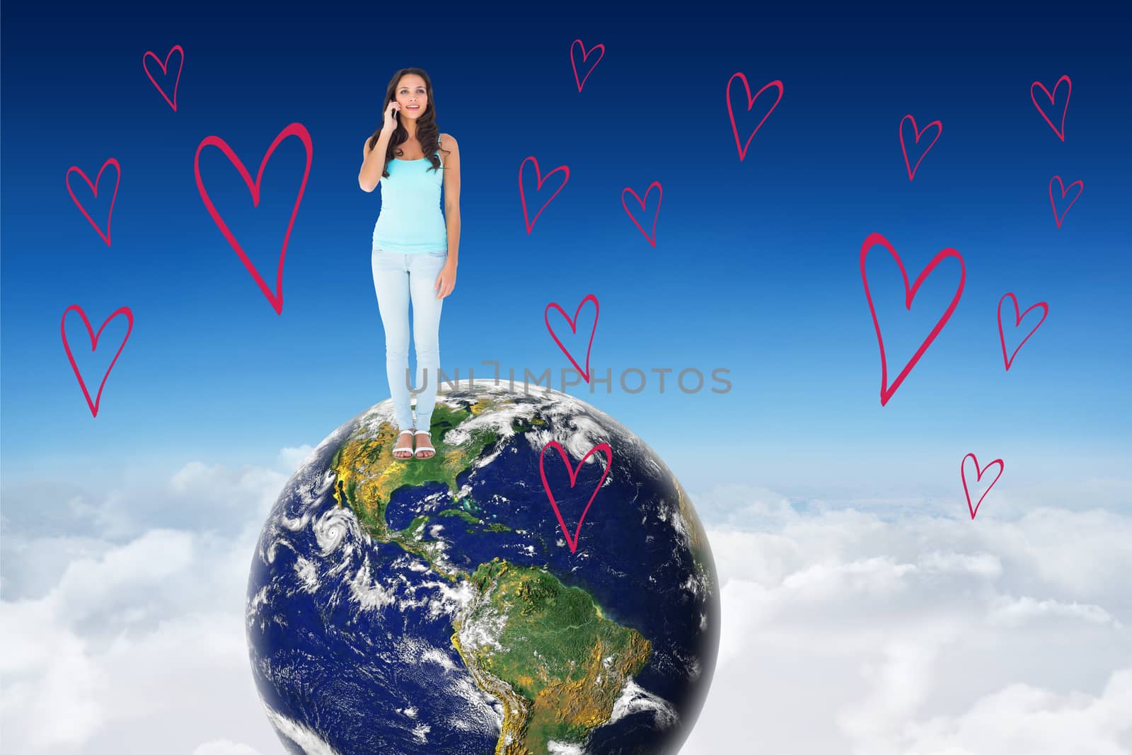 Casual brunette on the phone against blue sky over clouds