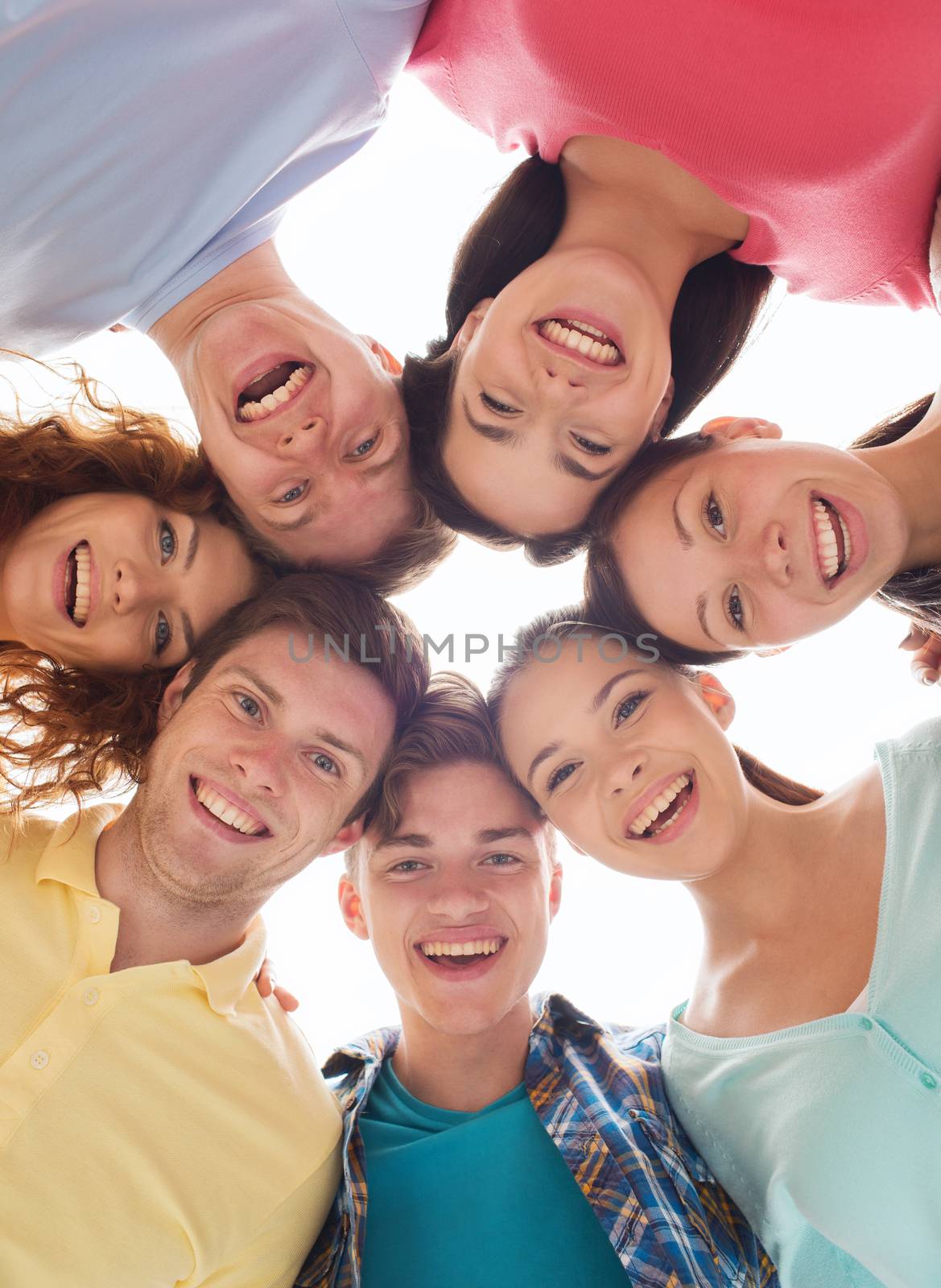 friendship, youth and people - group of smiling teenagers in circle