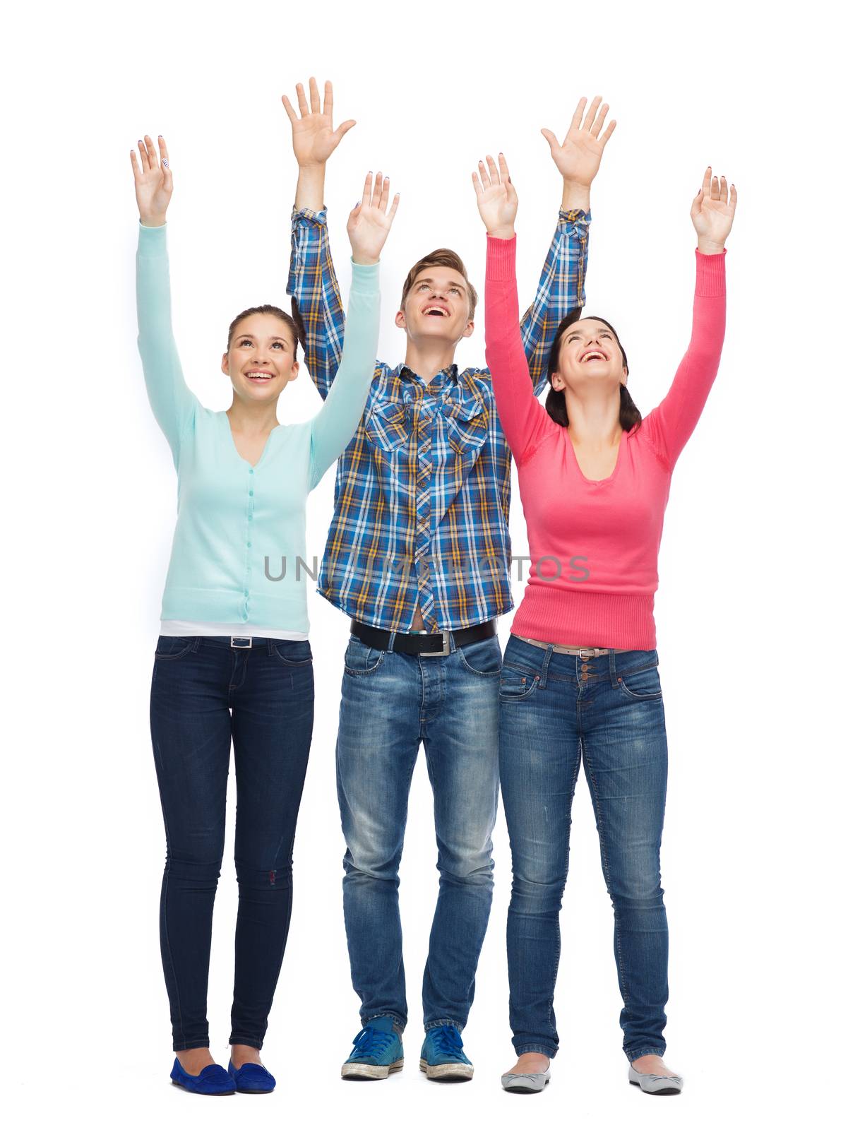 group of smiling teenagers with raised hands by dolgachov