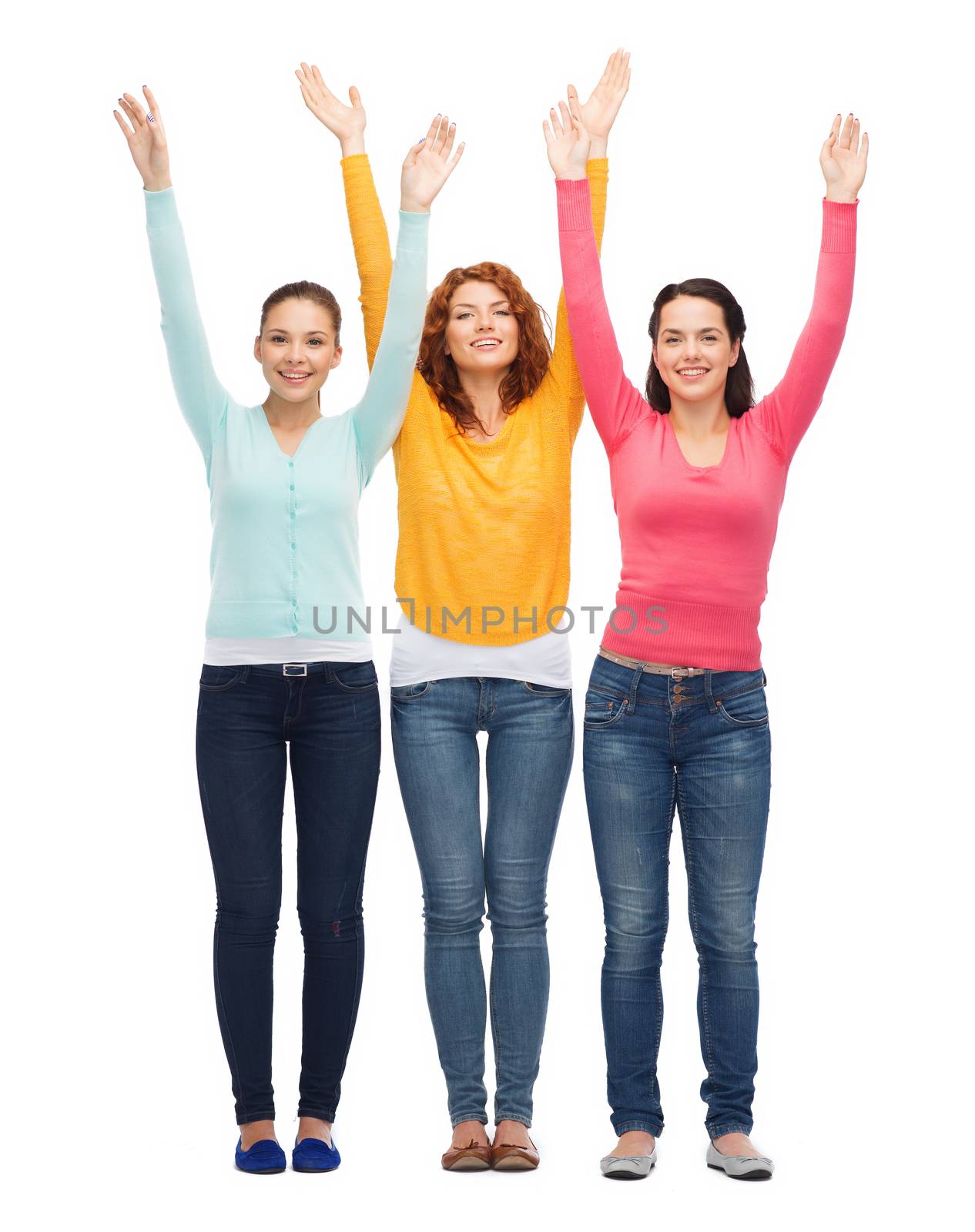 group of smiling teenagers with raised hands by dolgachov