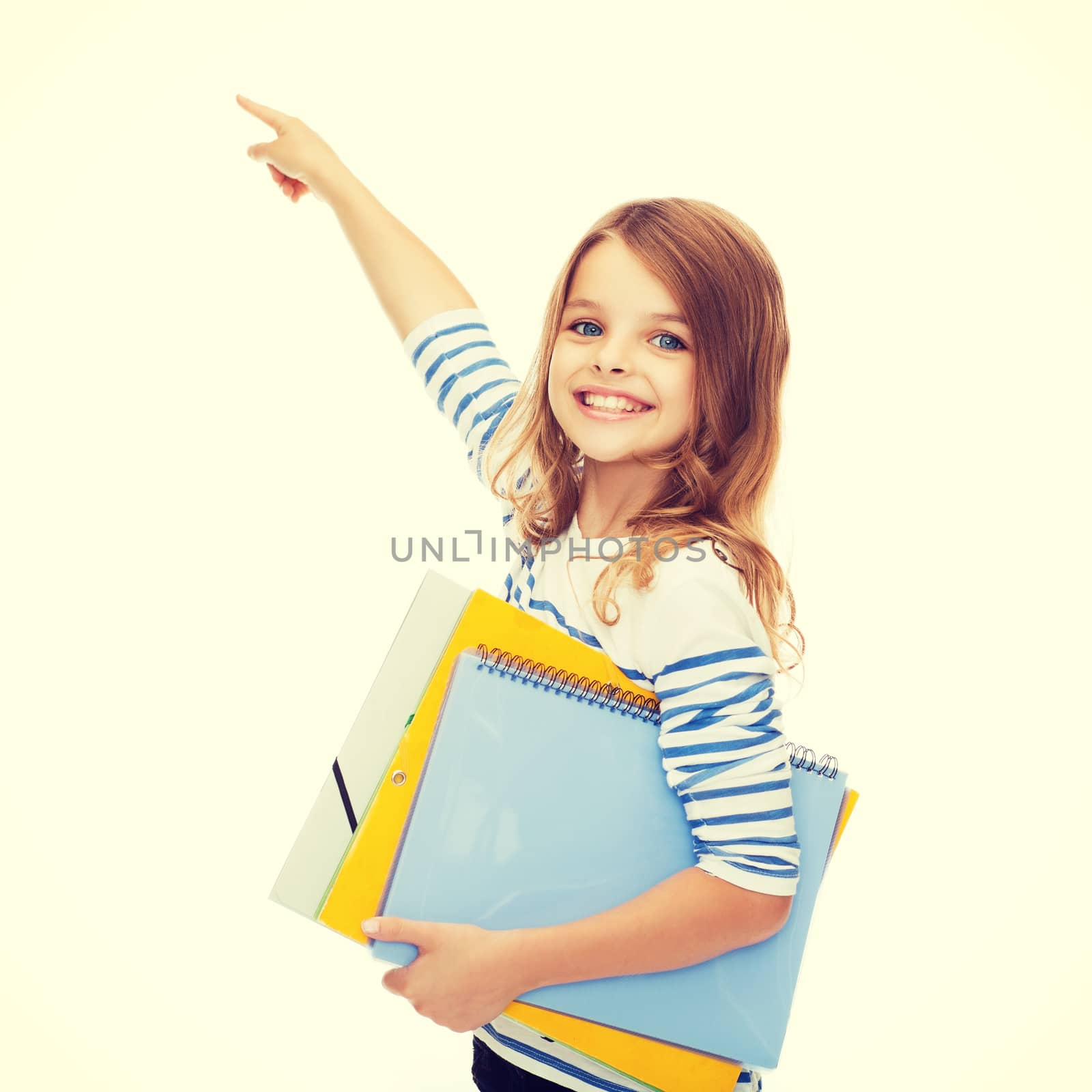 education, school and virtual screen concept - cute little girl with colorful folders pointing in the air or virtual screen