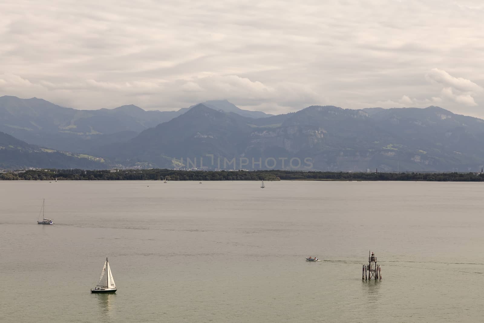 Sailboats on Bodensee with the mountains in the background