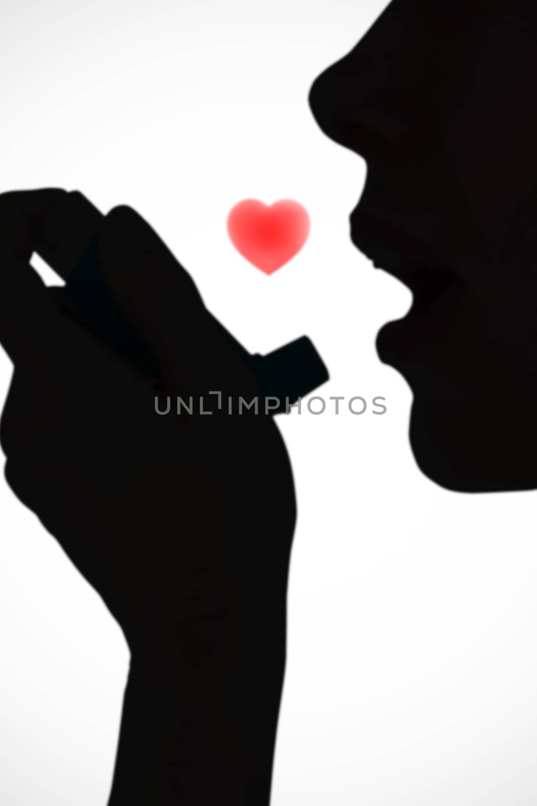 Close up of a woman using an asthma inhaler against white background with vignette