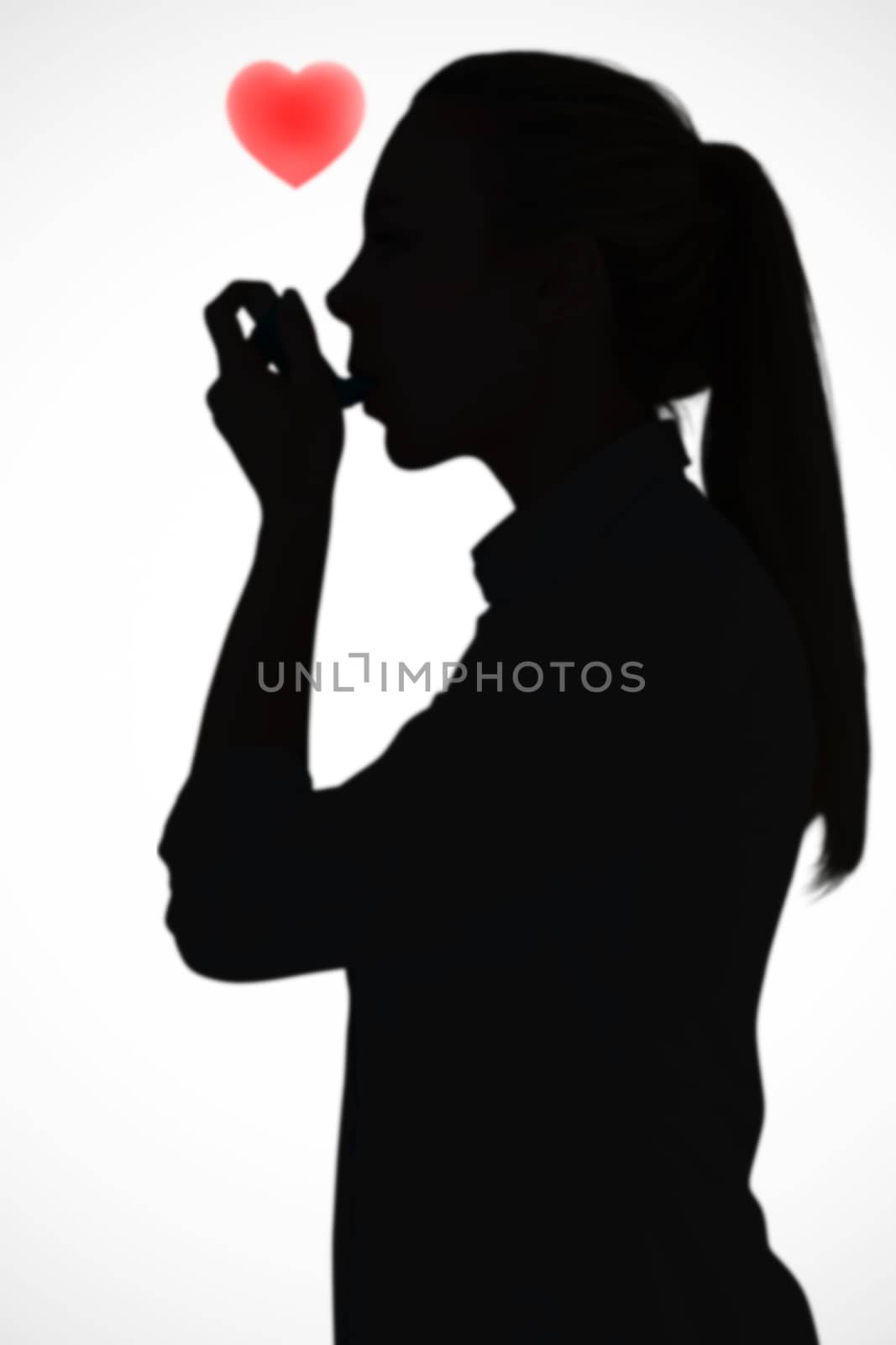 Composite image of beautiful blonde using an asthma inhaler by Wavebreakmedia