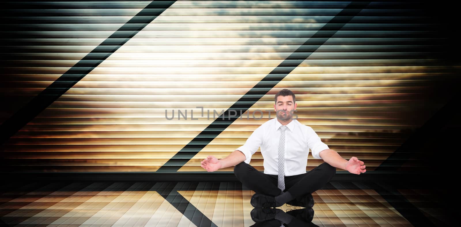 Businessman meditating in lotus pose against room with large window looking on landscape