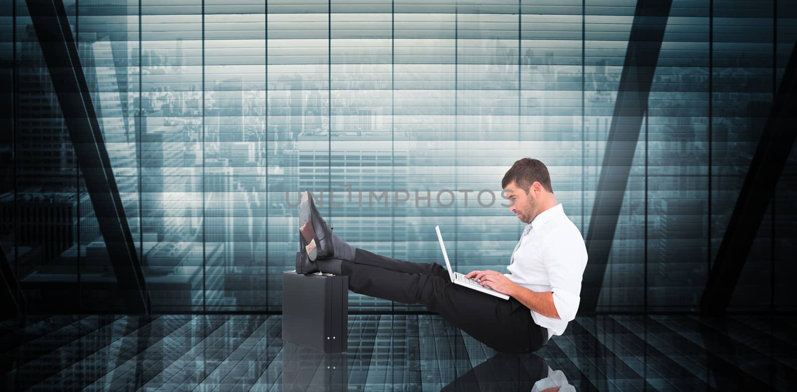 Businessman with feet up on briefcase against room with large window looking on city