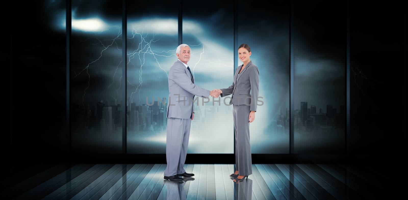 Business team shaking hands against room with large window looking on city