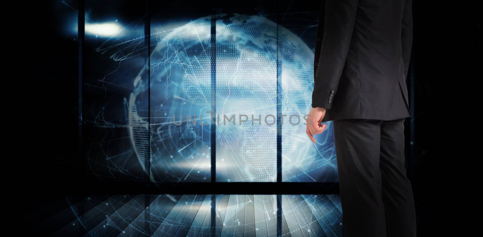 Businessman standing against global technology background in blue