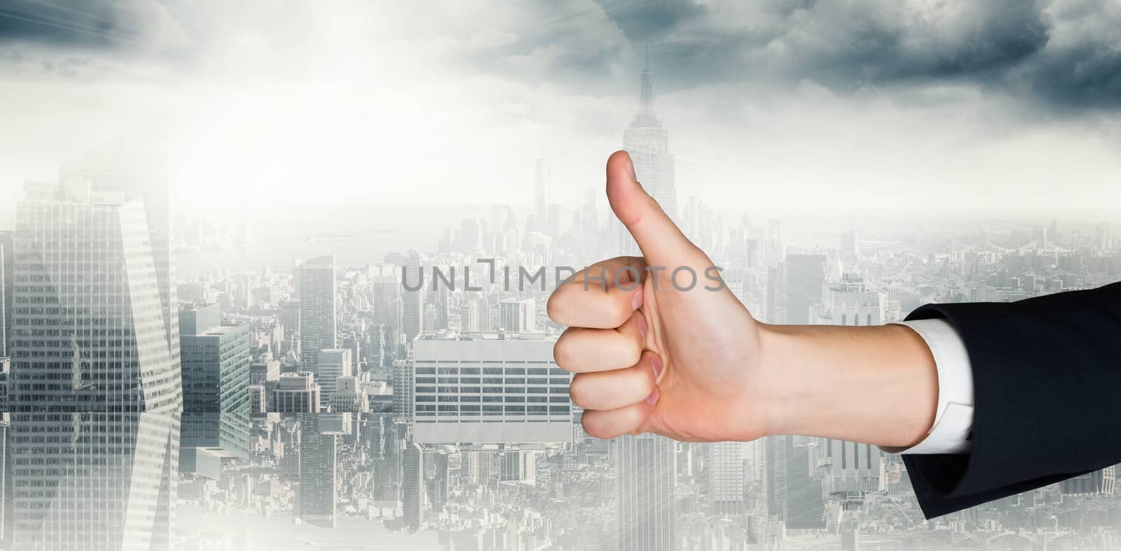 Hand showing thumbs up against room with large window looking on city