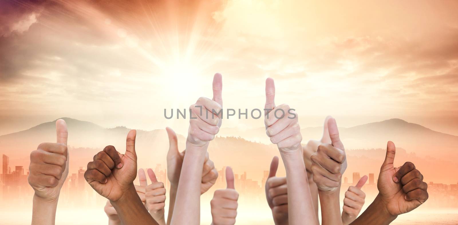 Hands showing thumbs up against sun shining over road and city