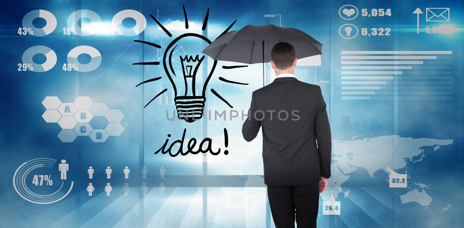 Businessman sheltering under black umbrella against futuristic technology interface