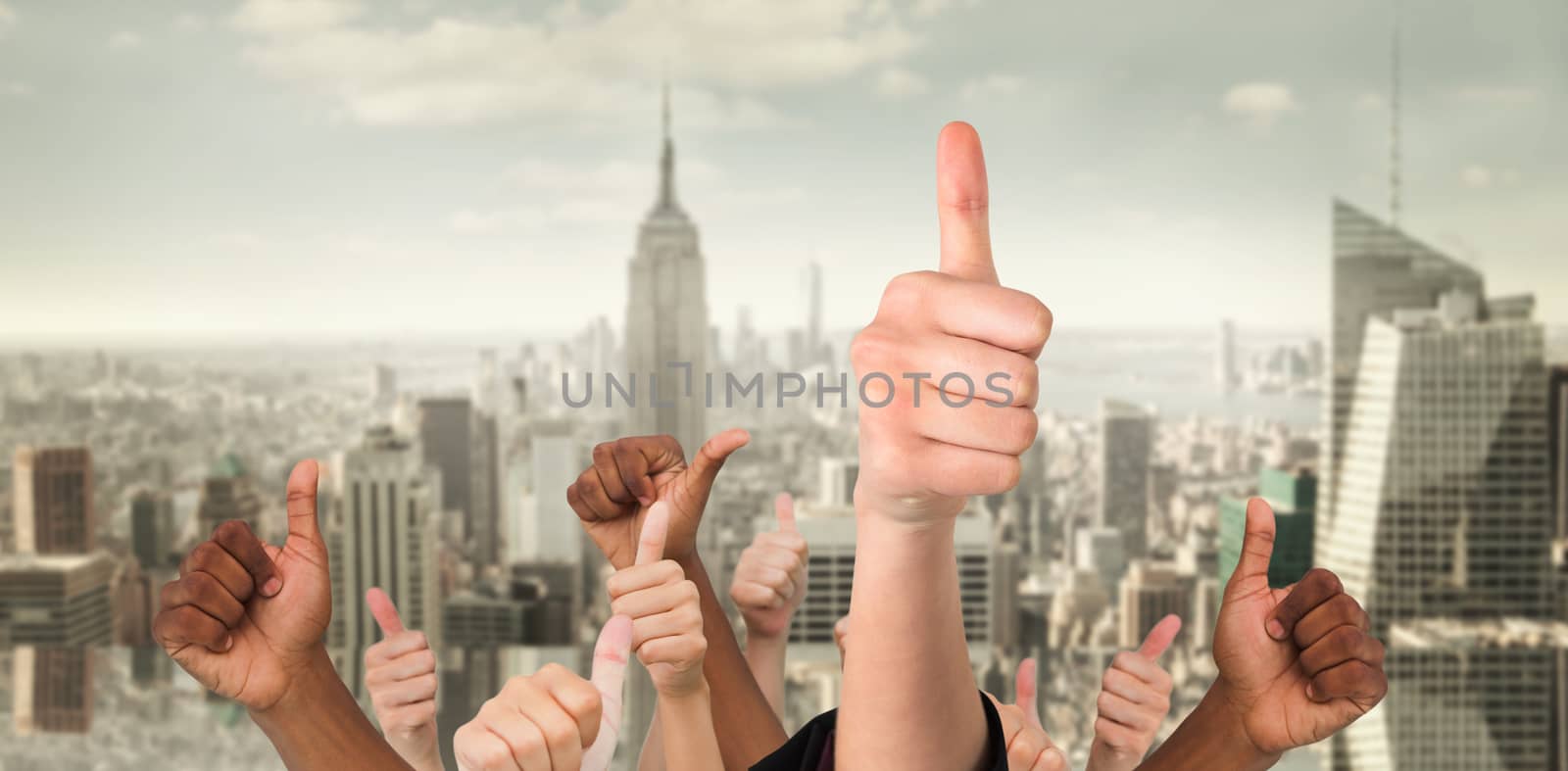 Hands showing thumbs up against room with large window looking on city